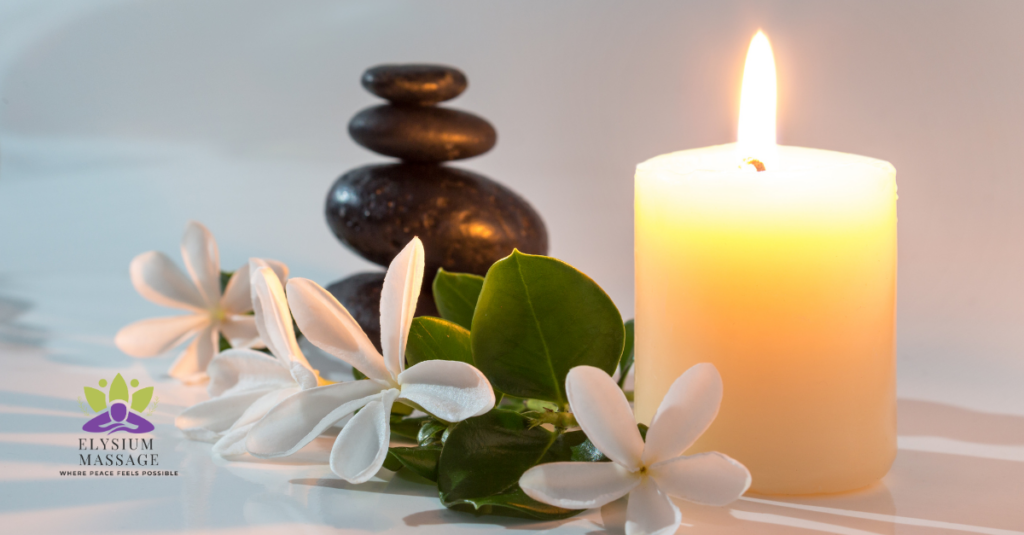 a lit candle, flowers and stones for the spring refresh sale at elysium massage in yellow springs